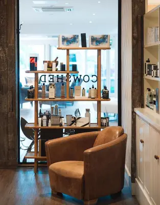 a store with a chair in front of a window at St Moritz Hotel Houses in Polzeath