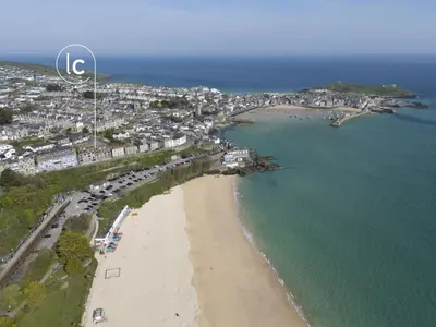 an aerial view of a beach and the ocean at Pink Sands, Carrack Widden, St Ives in St Ives