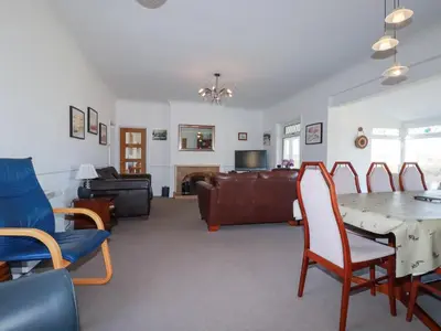 a living room with a table and chairs and a couch at 1 Atlantic View in Newquay