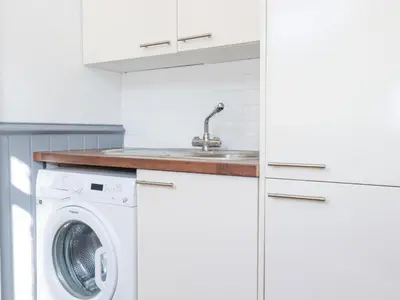 a kitchen with a washing machine and a sink at 1 Atlantic View in Newquay