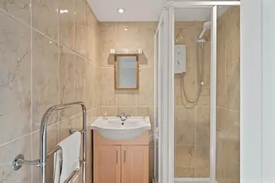 a bathroom with a sink and a shower at Homely Cottage & Garden nr Praa Sands & Marazion in Saint Hilary