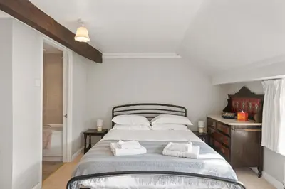 a bedroom with a bed with two towels on it at Homely Cottage & Garden nr Praa Sands & Marazion in Saint Hilary