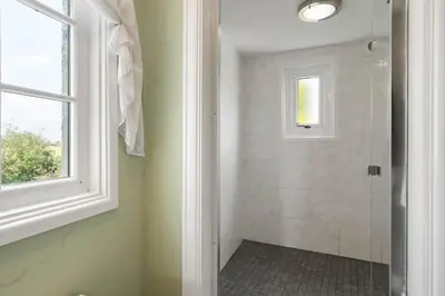 a bathroom with a shower and a window at Homely Cottage & Garden nr Praa Sands & Marazion in Saint Hilary