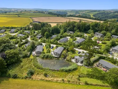 an aerial view of a house with a pond at 6 Meadow Retreat in Liskeard