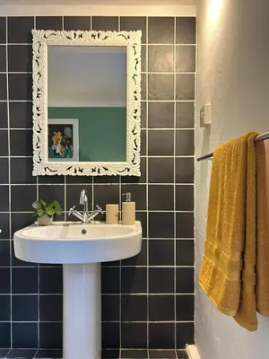 a bathroom with a sink and a mirror at 'Rocks' Sea Views with free parking in St Ives in St Ives