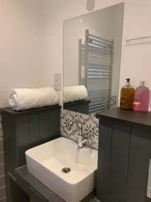 a bathroom with a sink and a mirror at First-Floor Georgian Apartment with Terrace and Sea Views in Boscastle in Boscastle
