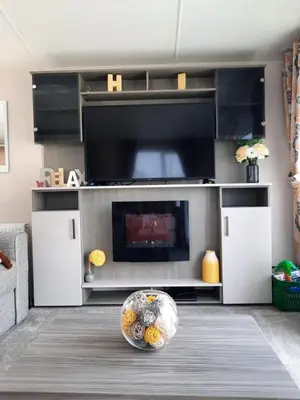 a living room with a television and a bowl on the floor at Luxury 6 berth caravan full decking in Saint Columb Minor