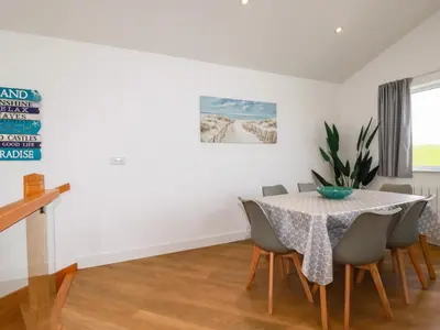 a dining room with a table and chairs at Jacana in Perranporth