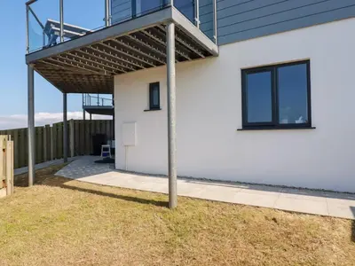 a house with a deck and a patio at Jacana in Perranporth