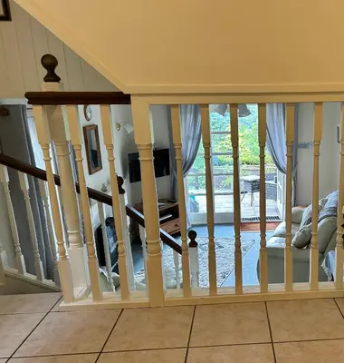 a staircase in a house with a view of a living room at Looe, Cornwall, Cottage, couples, romantic, quiet location, views, reliable Wi-Fi in Looe