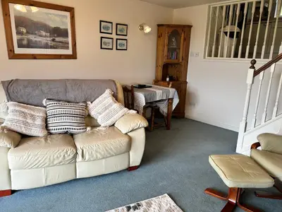 a living room with a couch and a table at Looe, Cornwall, Cottage, couples, romantic, quiet location, views, reliable Wi-Fi in Looe