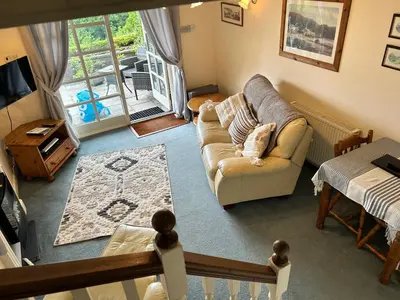 a living room with a couch and a table at Looe, Cornwall, Cottage, couples, romantic, quiet location, views, reliable Wi-Fi in Looe