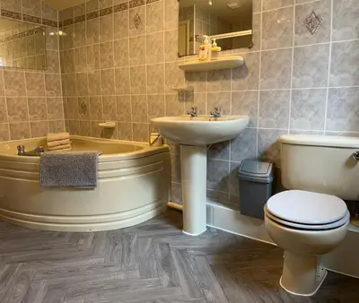 a bathroom with a tub and a toilet and a sink at Looe, Cornwall, Cottage, couples, romantic, quiet location, views, reliable Wi-Fi in Looe