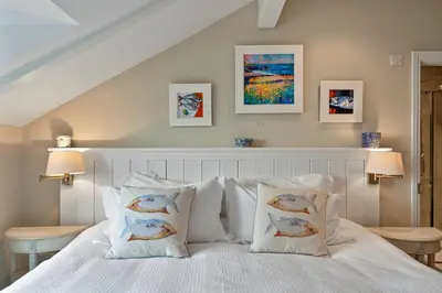 a bedroom with a bed with white sheets and pillows at Finest Retreats - St Eval School House in Saint Ervan
