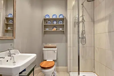 a bathroom with a shower and a toilet and a sink at Finest Retreats - St Eval School House in Saint Ervan