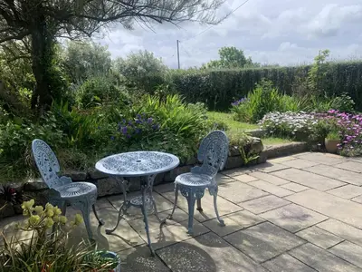 a table and two chairs sitting on a patio at Stargazy Skies in St. Agnes
