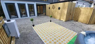 a yellow umbrella sitting on the ground in a yard at Sea La Vie in Perranporth