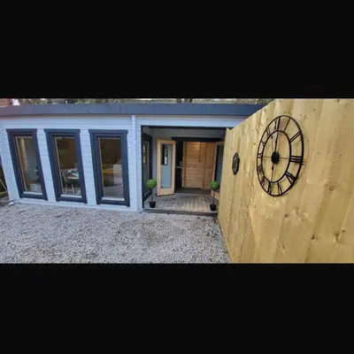 a house with a clock on the side of it at Sea La Vie in Perranporth