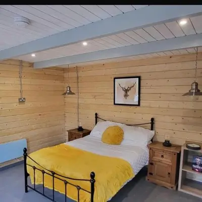 a bedroom with a bed with a yellow blanket at Sea La Vie in Perranporth