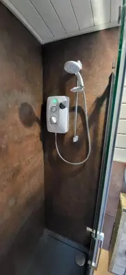a shower in a bathroom with a hair dryer at Sea La Vie in Perranporth