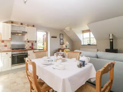 a kitchen and dining room with a table and chairs at The Hayloft in Lostwithiel