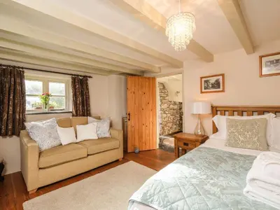 a bedroom with a bed and a couch at The Mill in Lostwithiel