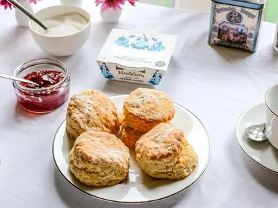 a white plate with four biscuits on a table at The Mill in Lostwithiel