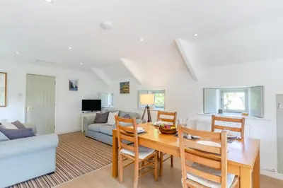 a dining room and living room with a table and chairs at 2 Bed in Launceston oc-t31002 in Lewannick