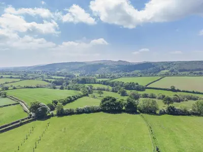 an aerial view of green fields and trees at 2 Bed in Launceston oc-t31002 in Lewannick