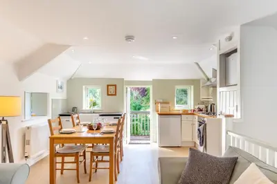 a kitchen and living room with a table and chairs at 2 Bed in Launceston oc-t31002 in Lewannick