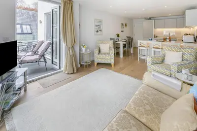 a living room with a couch and a kitchen at 2 Bed in Fowey oc-o31260 in Fowey