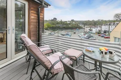 a patio with chairs and a table on a balcony at 2 Bed in Fowey oc-o31260 in Fowey