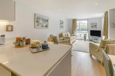 a kitchen and living room with a table and chairs at 2 Bed in Fowey oc-o31260 in Fowey
