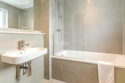 a bathroom with a sink and a bath tub at 2 Bed in Fowey oc-o31260 in Fowey