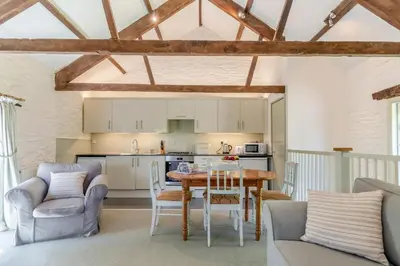 a kitchen and living room with a table and chairs at 2 Bed in Launceston oc-d31000 in Lewannick