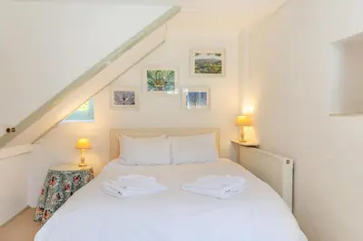 a bedroom with a white bed with two towels on it at 2 Bed in Launceston oc-d31000 in Lewannick