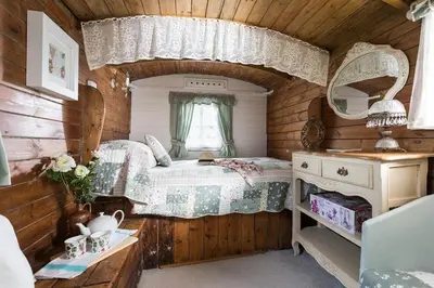 a bedroom with a bed and a mirror in a room at Birdsong in St. Issey