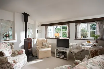 a living room with a couch and a tv at Birdsong in St. Issey