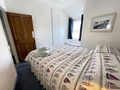 a bedroom with a bed with a quilt on it at Penty Men Growyn in St Ives
