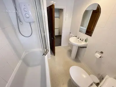 a bathroom with a toilet and a sink and a shower at Penty Men Growyn in St Ives