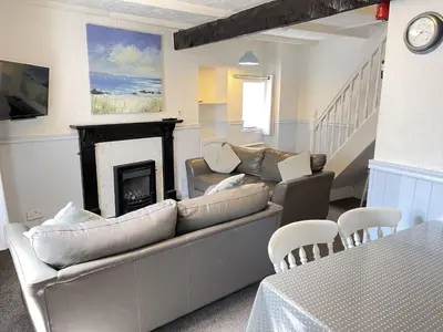 a living room with a couch and a fireplace at Penty Men Growyn in St Ives