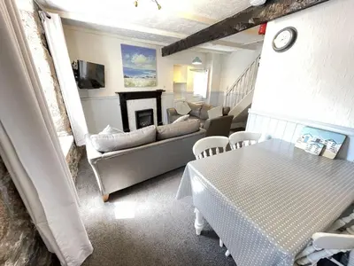 a living room with a couch and a table at Penty Men Growyn in St Ives