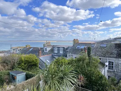 a group of houses with the ocean in the background at 9 Bowling Green Terrace in St Ives