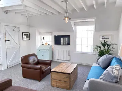 a living room with a couch and a coffee table at Norway House Studio in St Ives