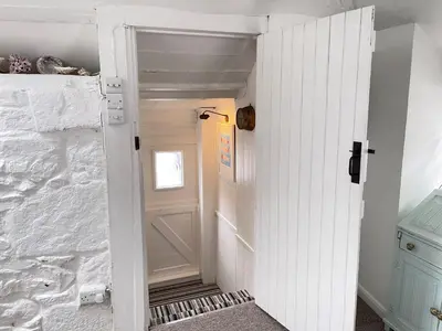 a white door leading into a room with a white wall at Norway House Studio in St Ives