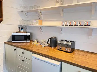 a kitchen with a counter with a toaster and a microwave at Norway House Studio in St Ives