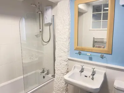 a bathroom with a sink and a shower at Norway House Studio in St Ives