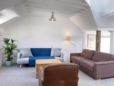 a living room with a couch and a table at Norway House Studio in St Ives