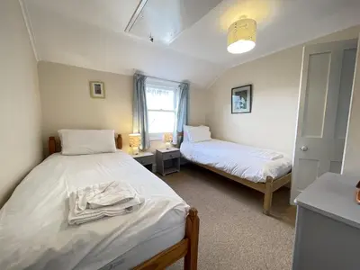 a bedroom with two beds and a window at Windjammer in St Ives