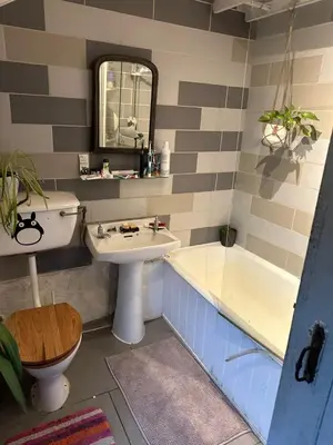 a bathroom with a sink and a tub and a toilet at Greenbank Farm in Falmouth